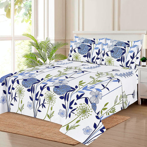 Blue Botanical Floral Comforter Set with matching pillow shams on a bed in a bright bedroom, white with blue roses and green botanical stems pattern